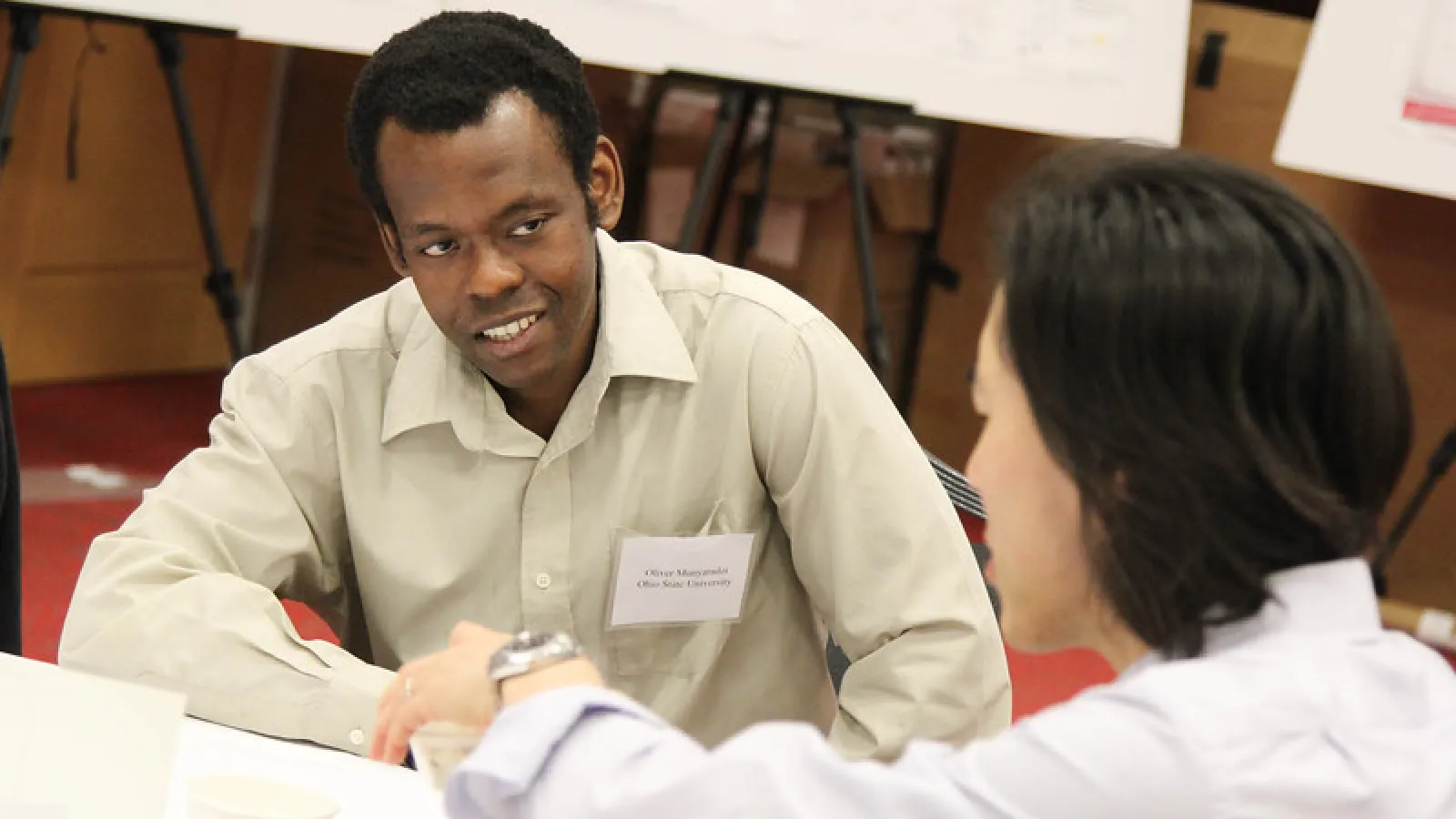 Colleagues conversing at the annual symposium