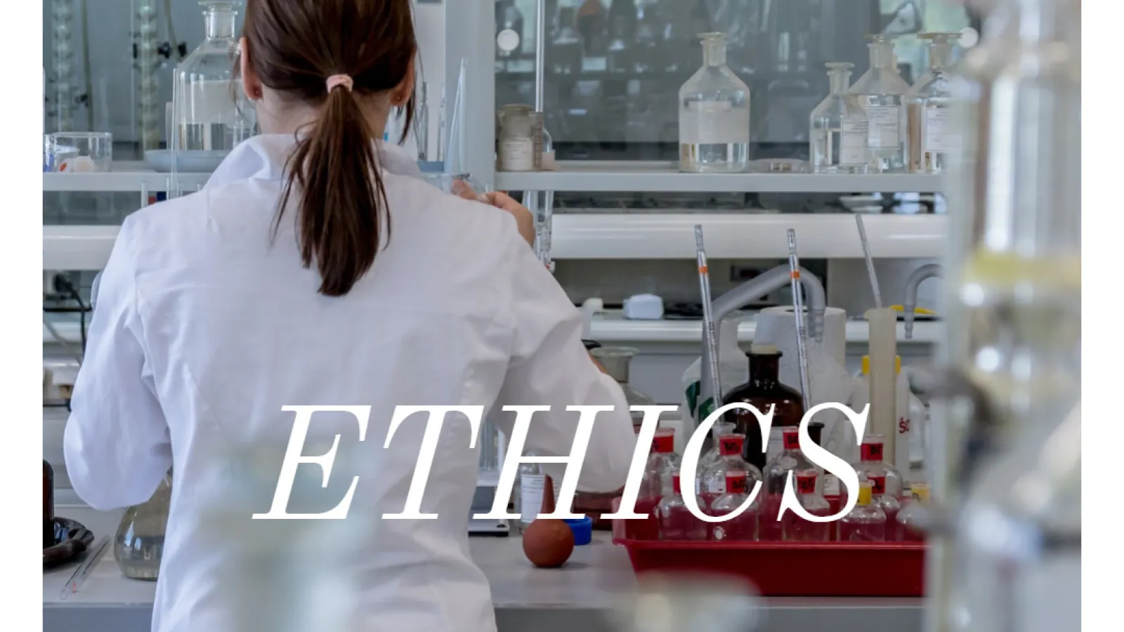 Picture of research being performed in a lab, with word "ethics" as accompanying text